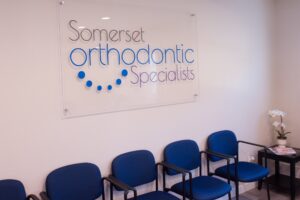 Somerset Orthodontic Specialists logo above the Hillsborough waiting room chairs
